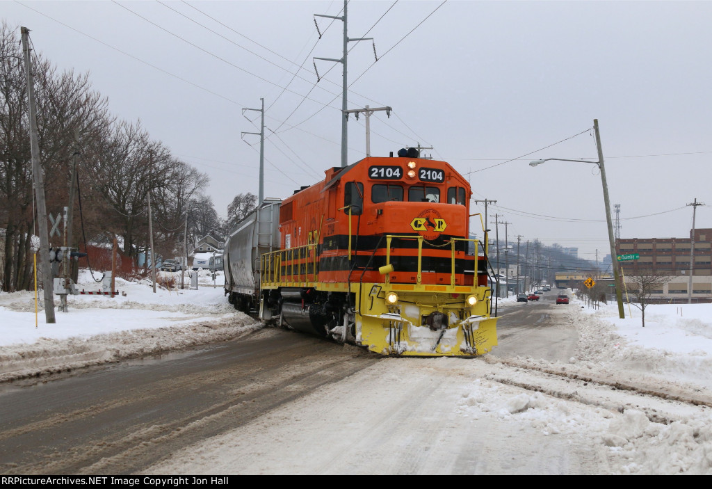 Crossing the slushy Taylor Ave, 2104 nears Ann St Yard